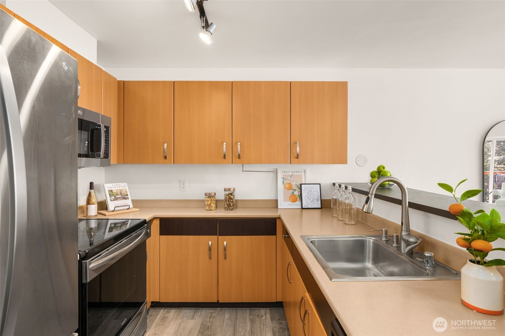 Contemporary cabinets provide plenty of storage space. Track lighting in kitchen is chef's delight!