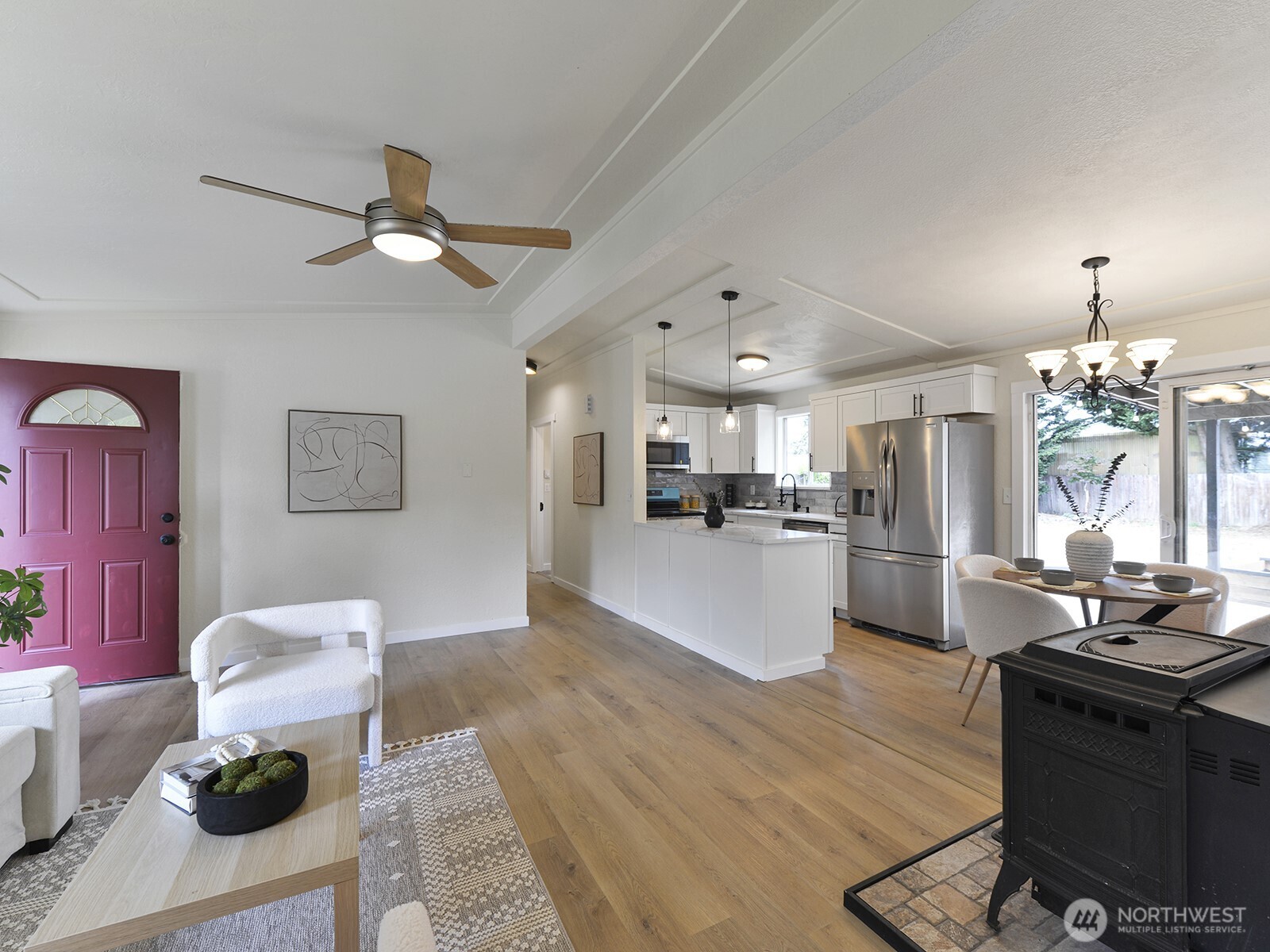 Open concept living space leading to light & bright kitchen & dining area
