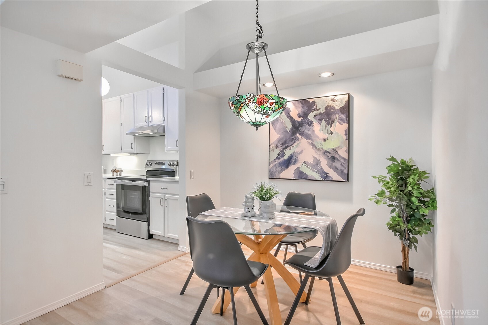 Dining room with high ceilings and luxury vinyl plank floors.
