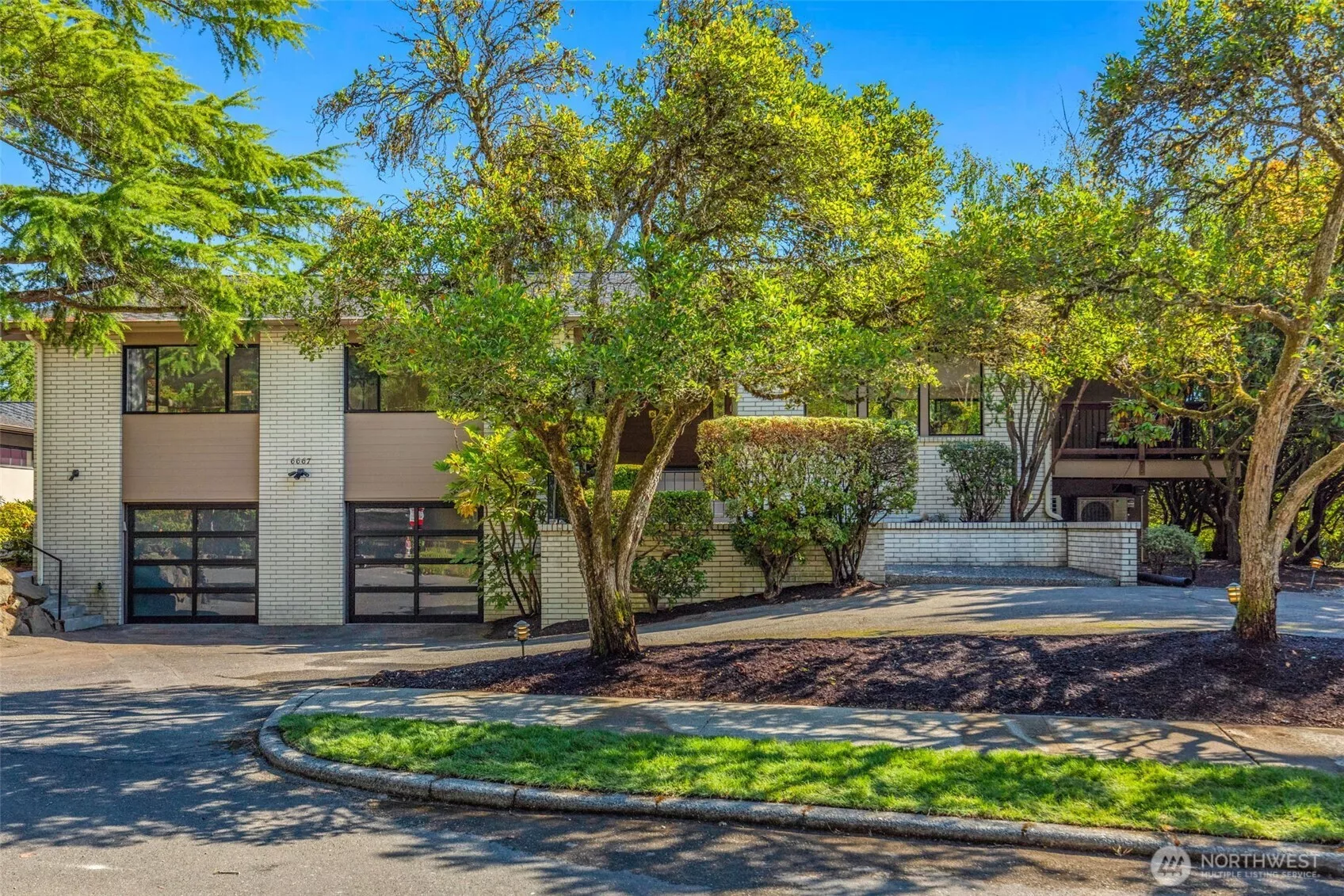 Versatile grounds on an 11,700 sq foot lot with Ipe deck, lower patio and level grassy area with gardening space and privacy