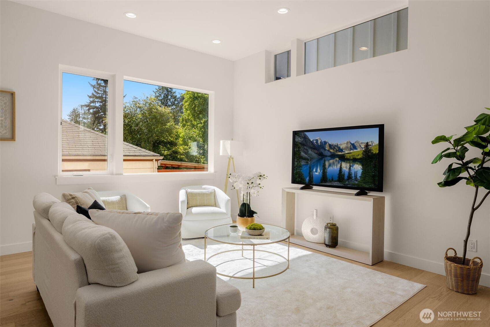 Bright living room with tree-lined outlooks.