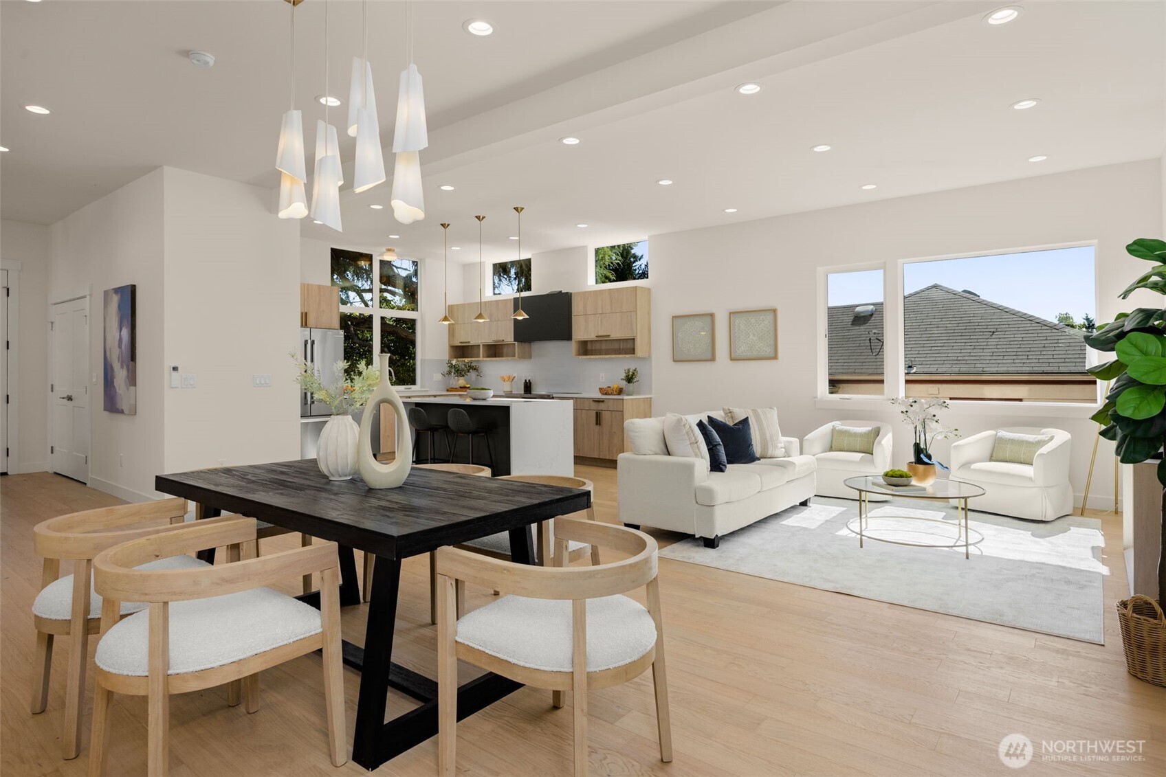 Living rooms flows into the dining area framed by natural light.
