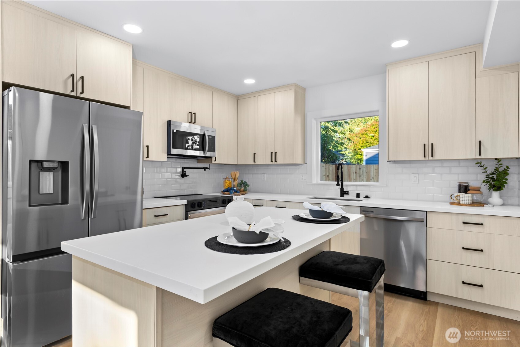 Kitchen w/ island/ black stainless-steel appliances/ Quartz countertops