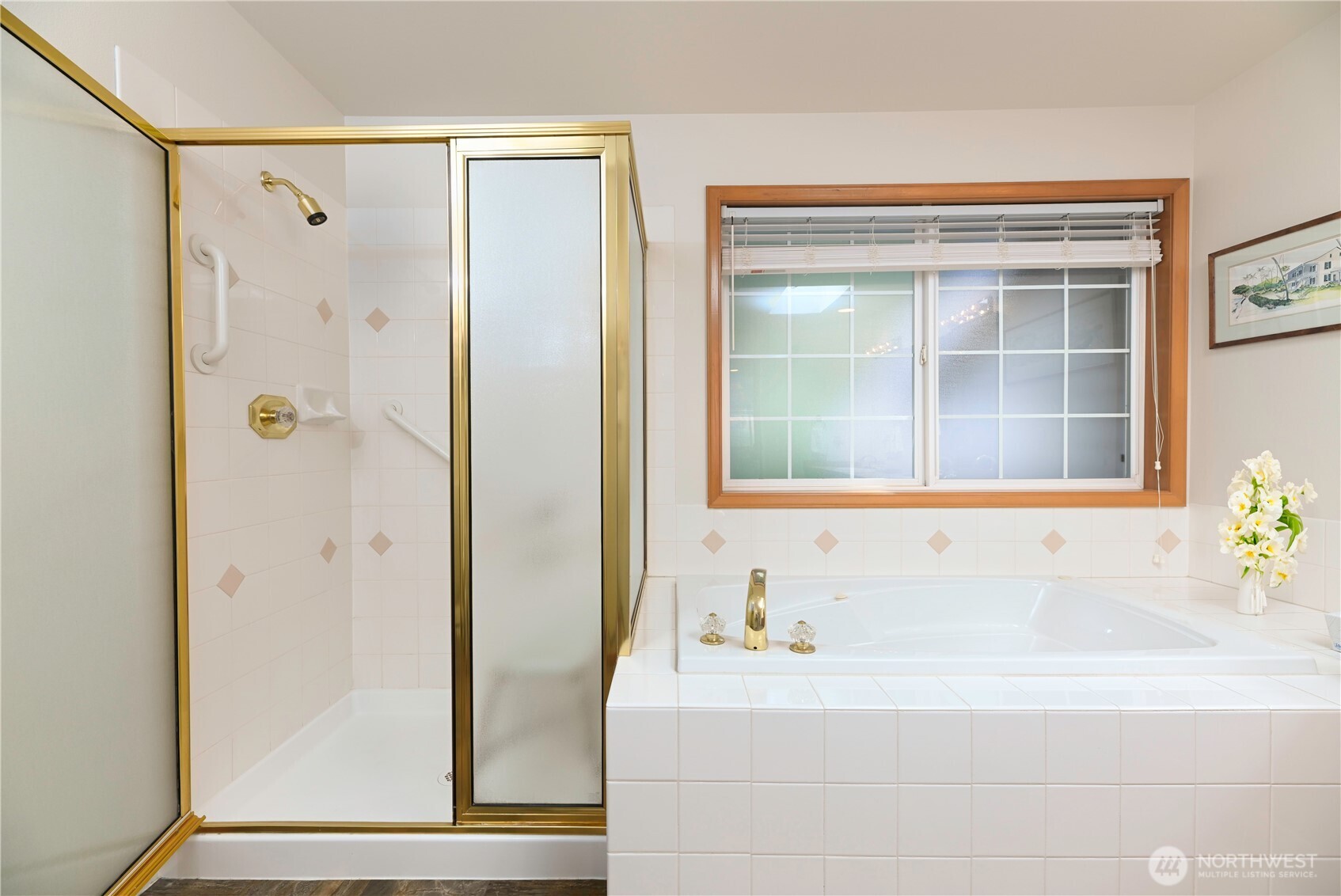 Primary bath with jetted tub and double sink vanity.