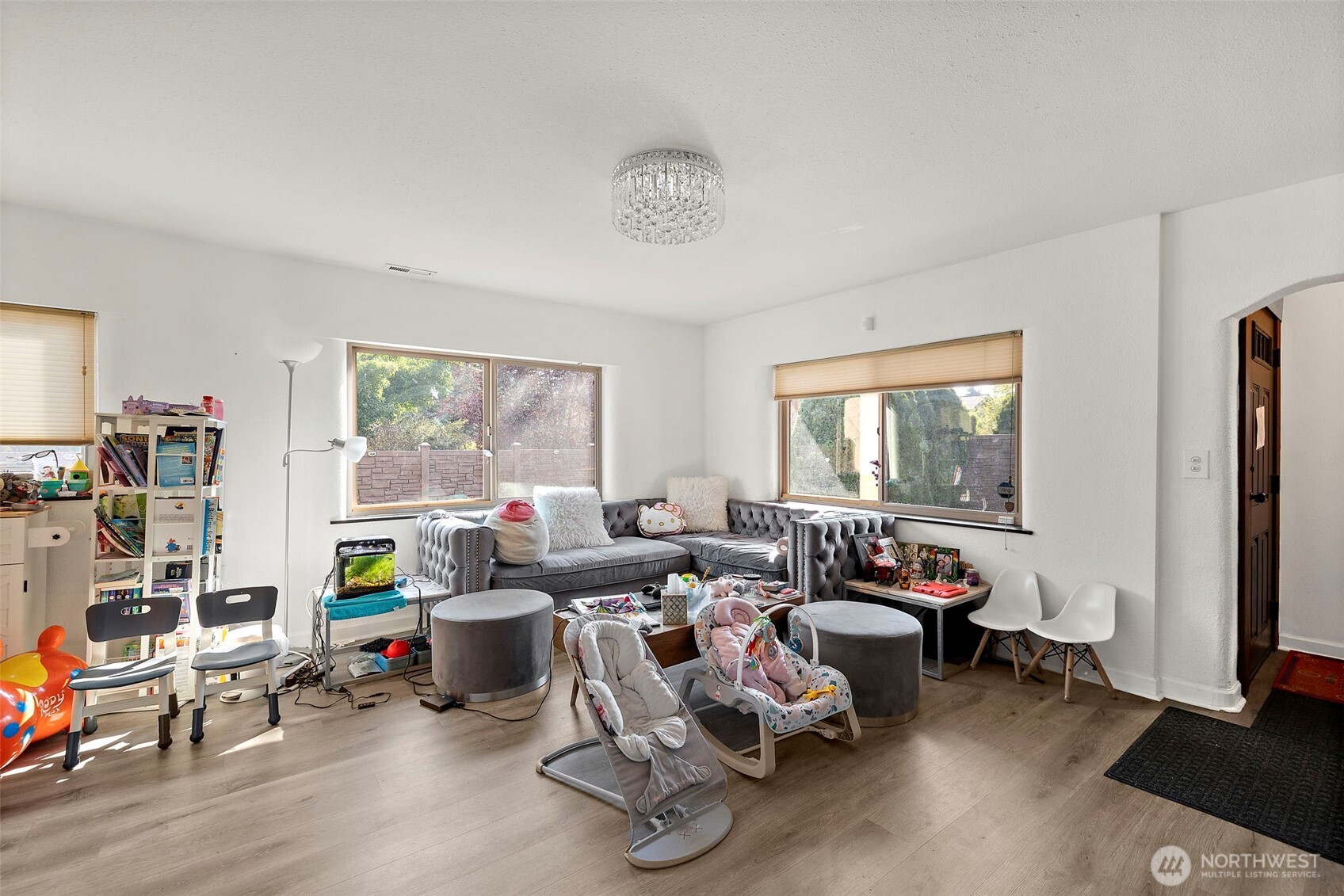 Living room with front door entrance to the right.