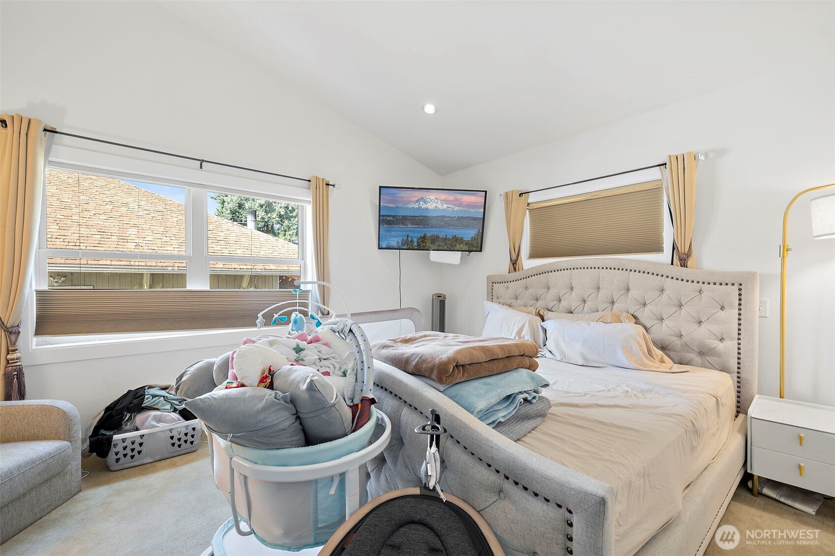Primary bedroom with pitched ceilings.