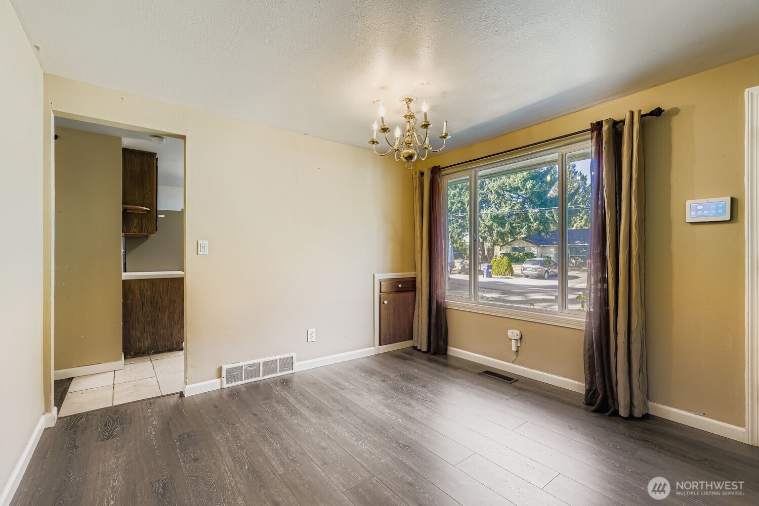Dining room with a chandelier and small built-in for tablecloths, napkins, and candlesticks.