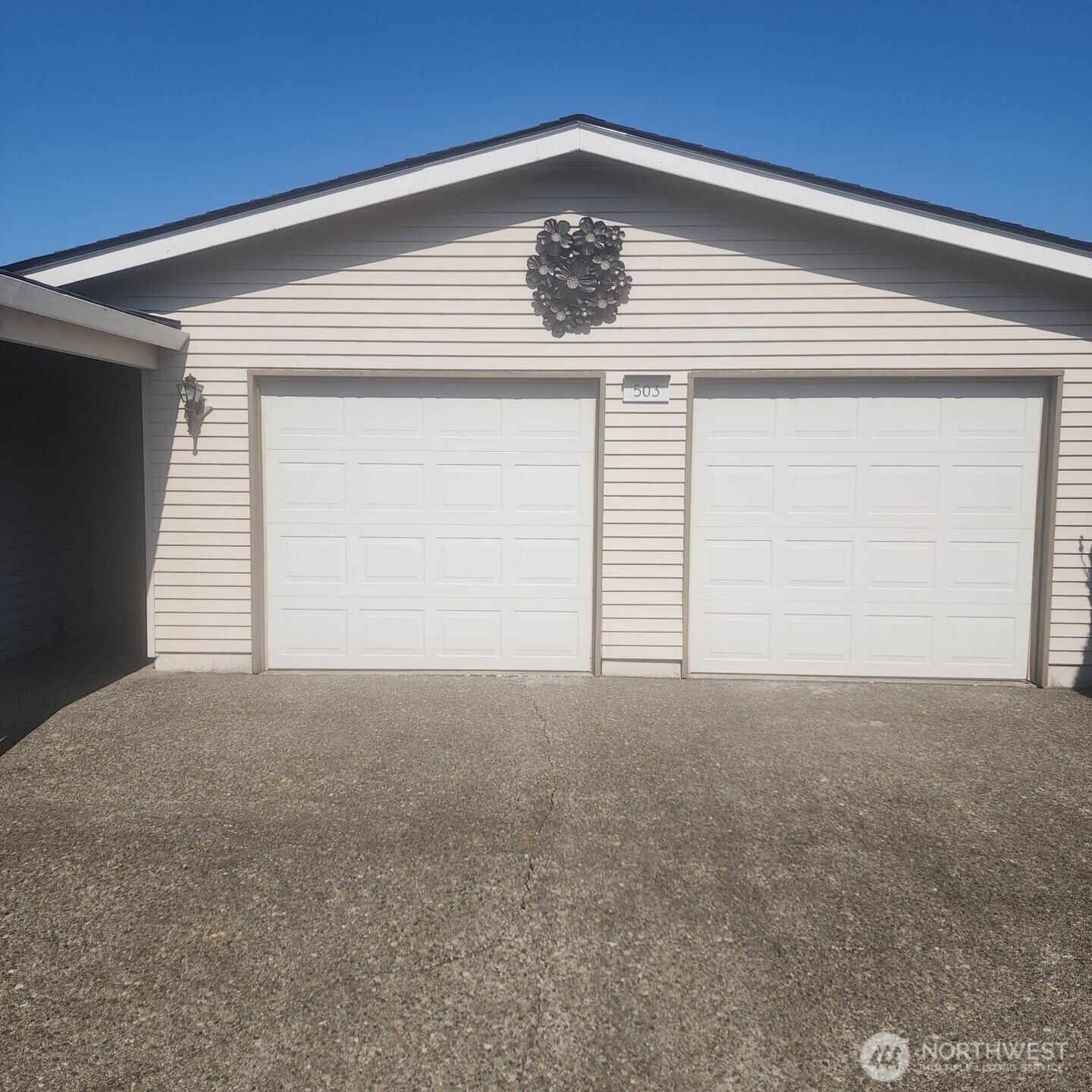Standing tall, two car garage with openers. Garage and home have newer roof and gutters.
