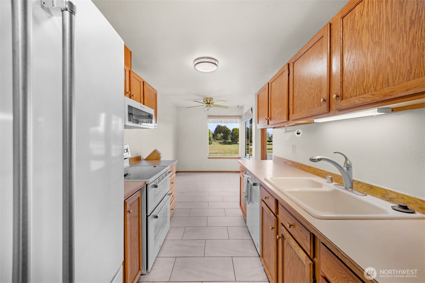 Roomy kitchen with ample cabinet and counter space.