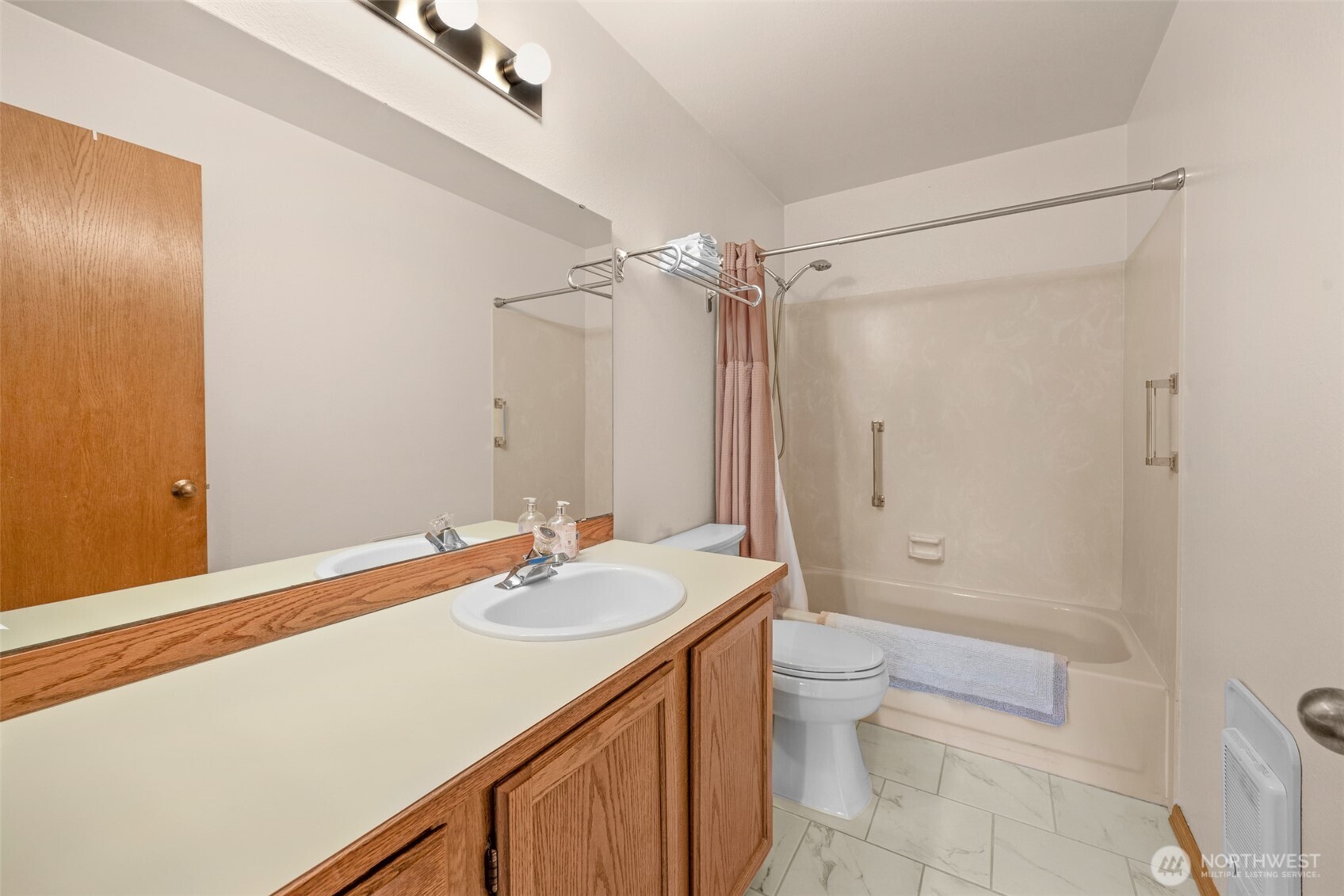 Full bath with tile flooring.