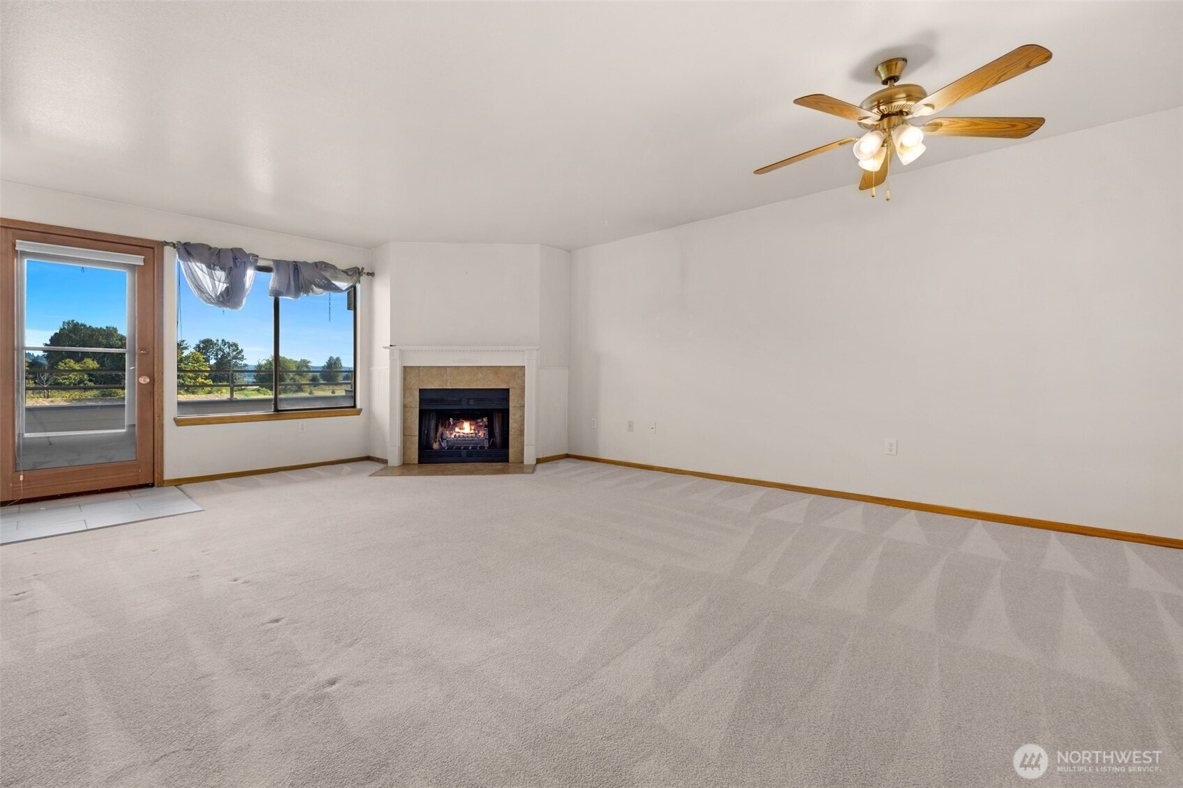 Large living room with fireplace. Door to access your covered deck.