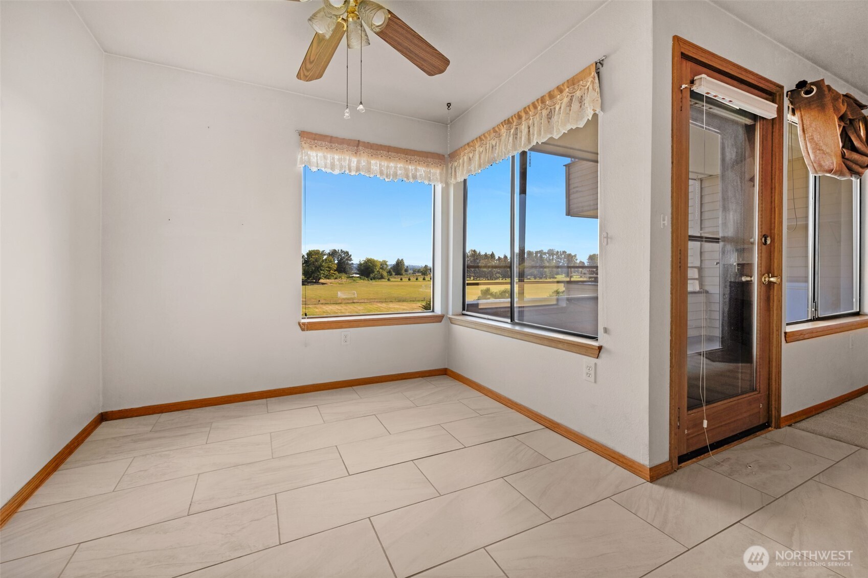 Dining area with views out over the soccer fields to the East. Italian tile flooring for easy care.