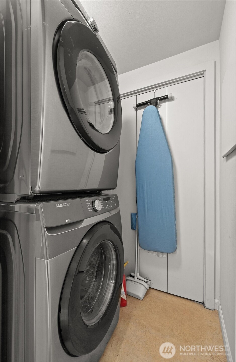 Stacked Samsung Washer/Dryer in separate utility room closet.