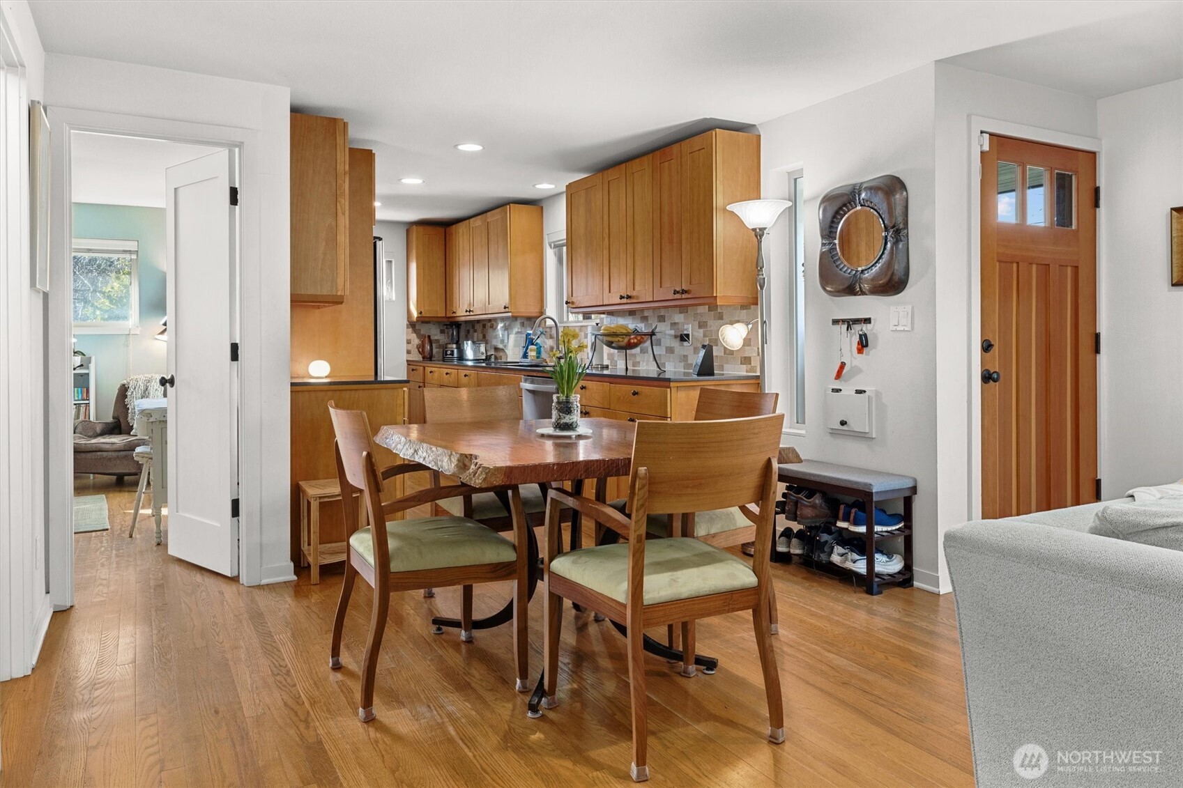 Dining area that defines an open boundary between kitchen and living room. Beautiful oak hardwood floors on this level.