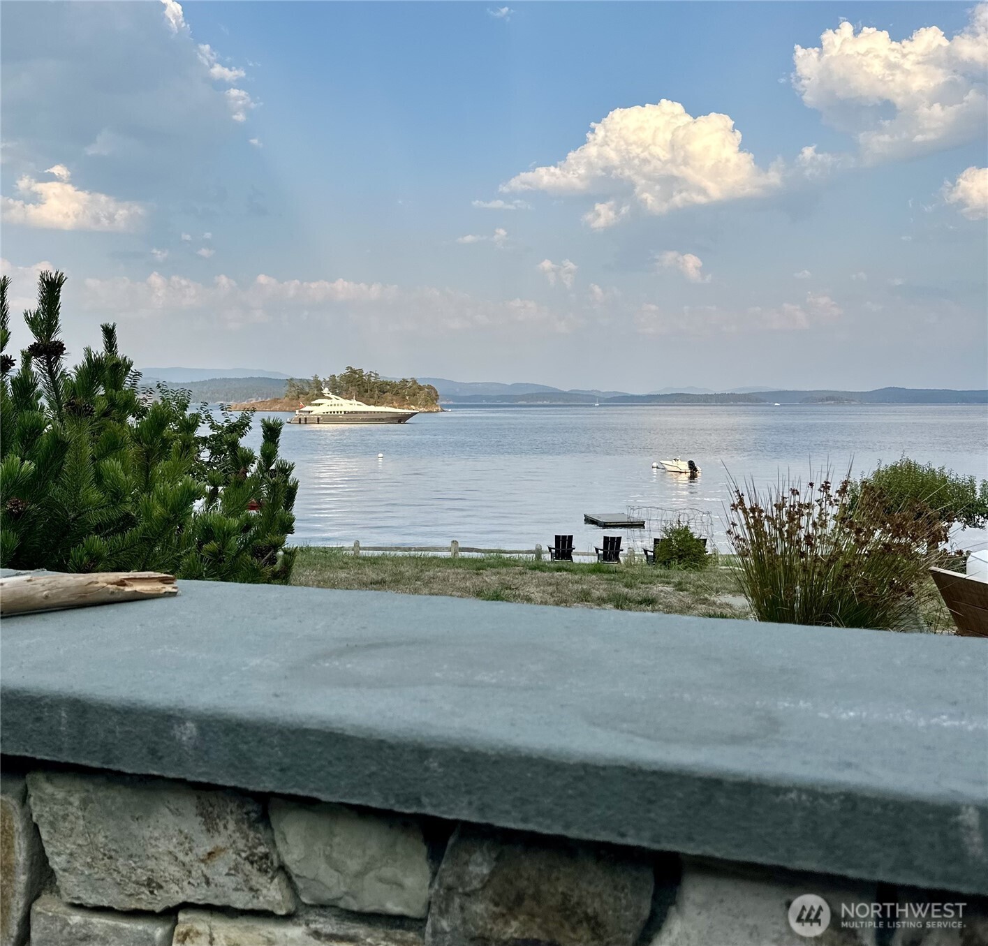 In addition to the mooring buoy, Rocky Bay offers safe anchorage for larger vessels too.  Just beyond the property's mooring buoy is the yacht, Lady L (147 ft).  She sat at anchor for 3 days. O'Neil Island in the background.