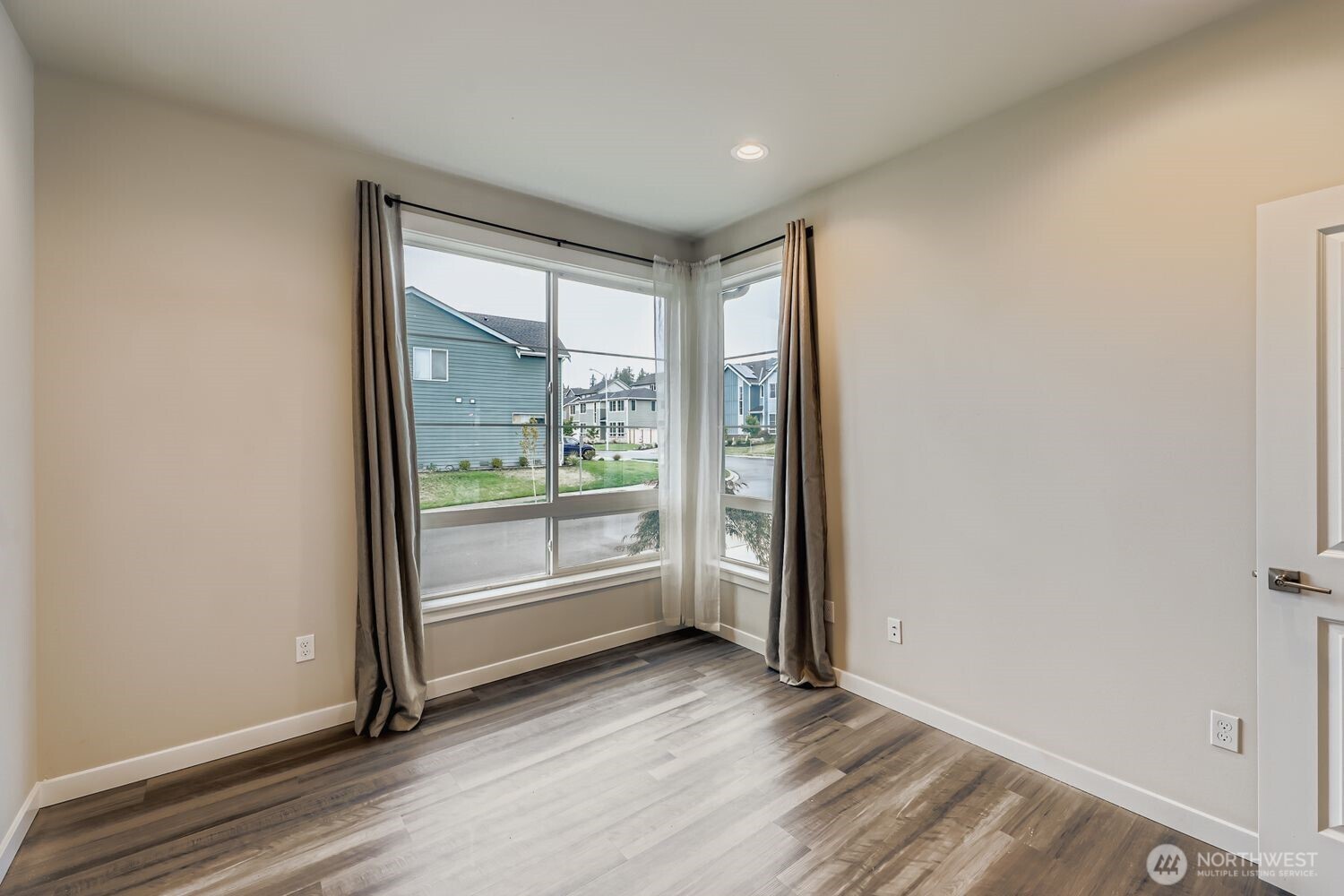 View from garage entry with coat rack and access to walk-in pantry.
