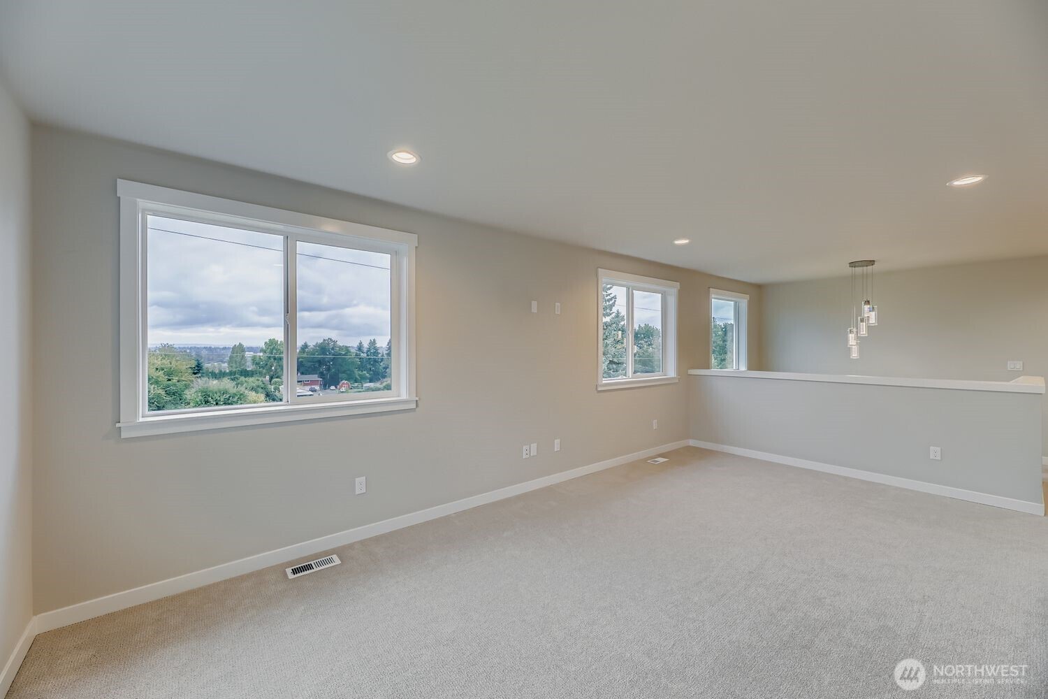 Upstairs rec room with south and west-facing windows providing natural light and views.