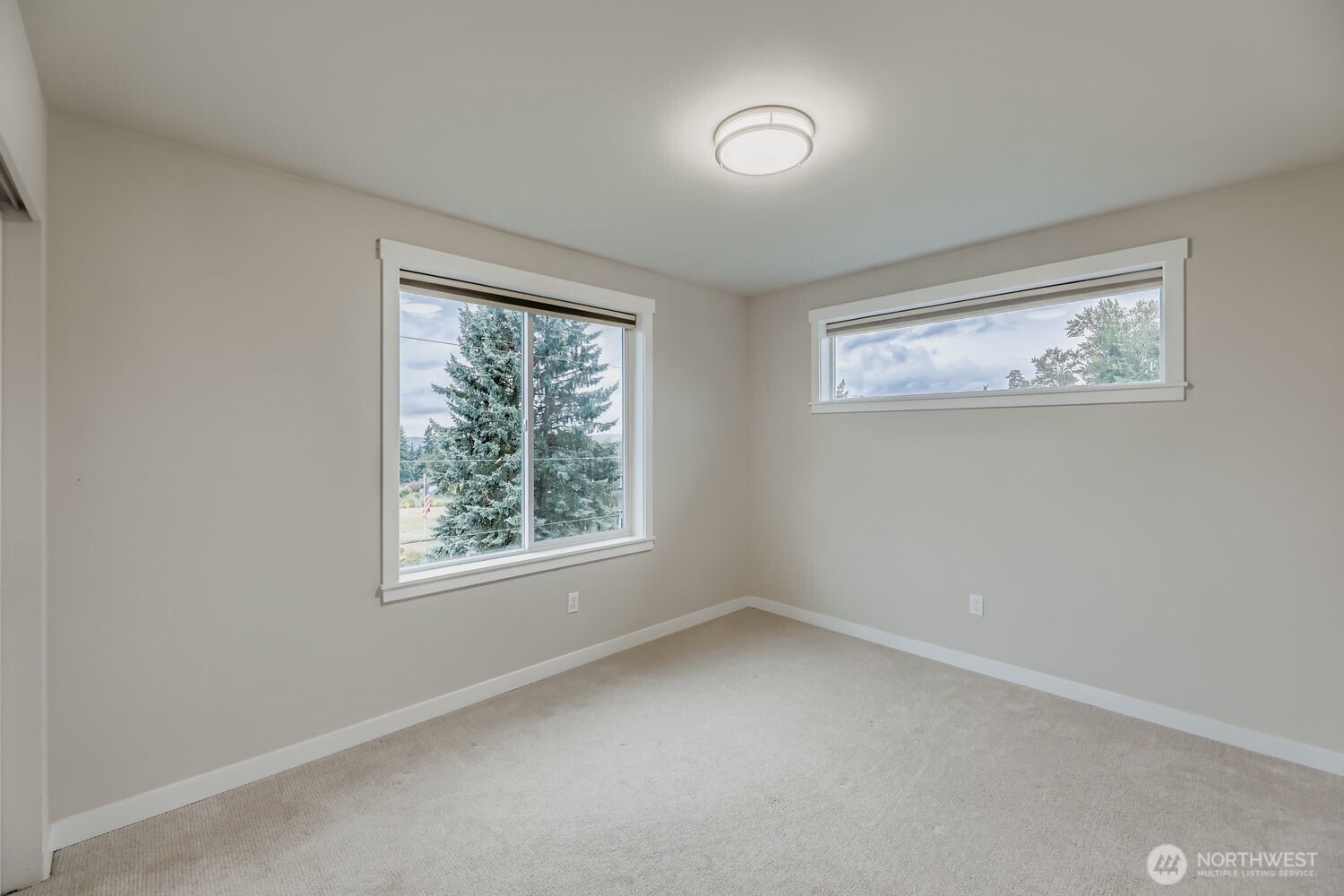 Primary walk-in closet with built-in shelving.