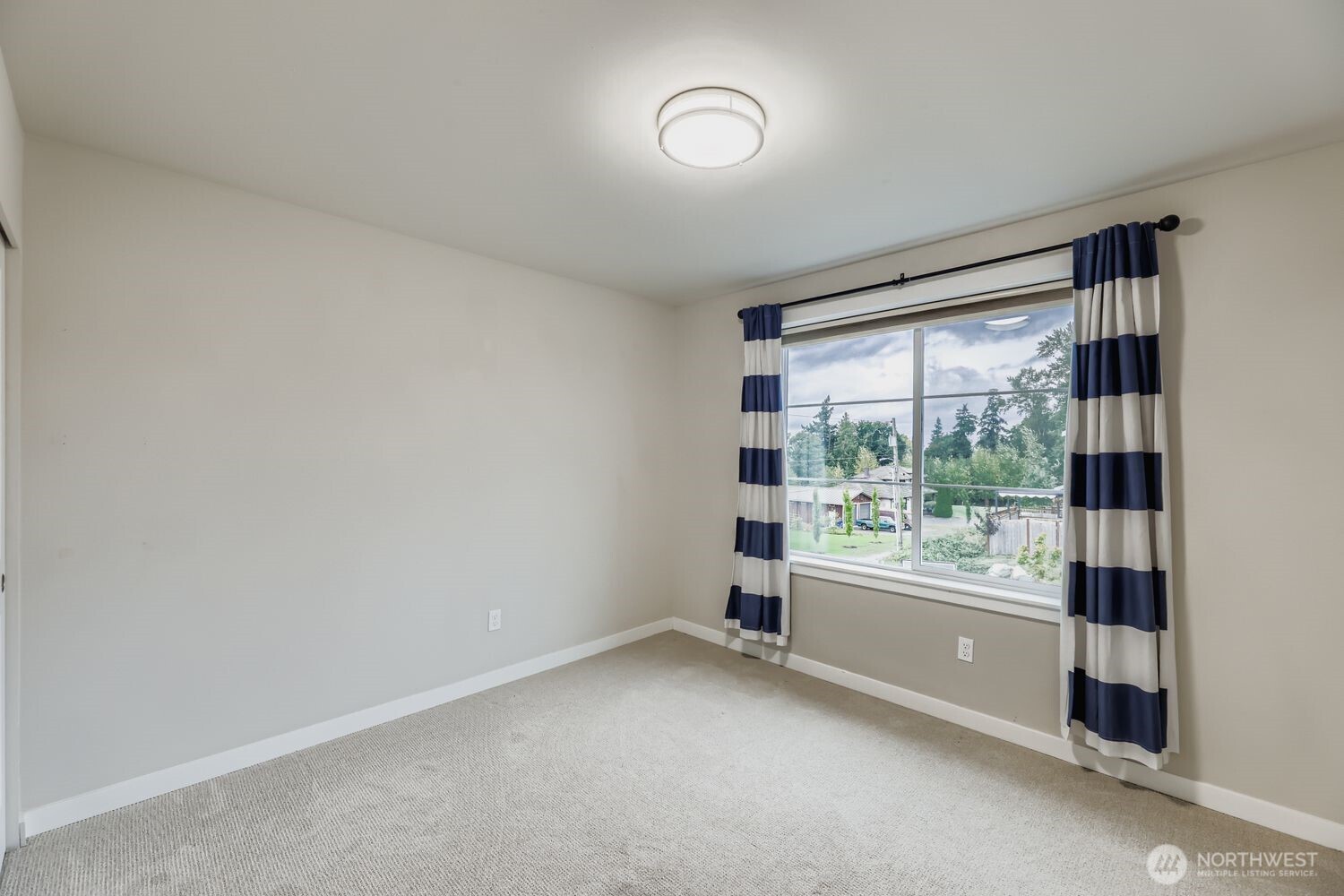 Secondary bedroom with natural light, west views, and closet.