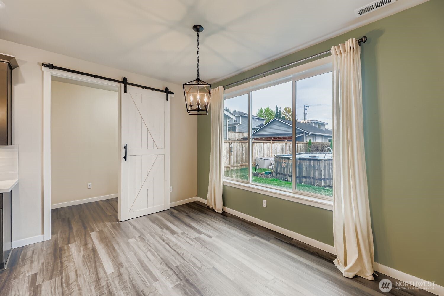 View from kitchen across island to great room with fireplace and open layout.