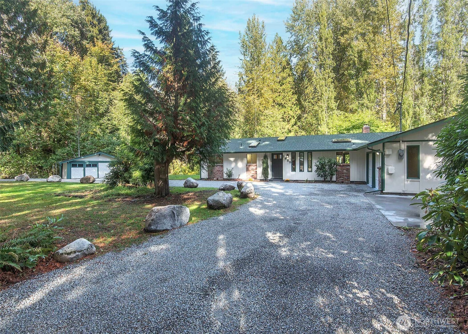 Home and shed with a wrap around drive.