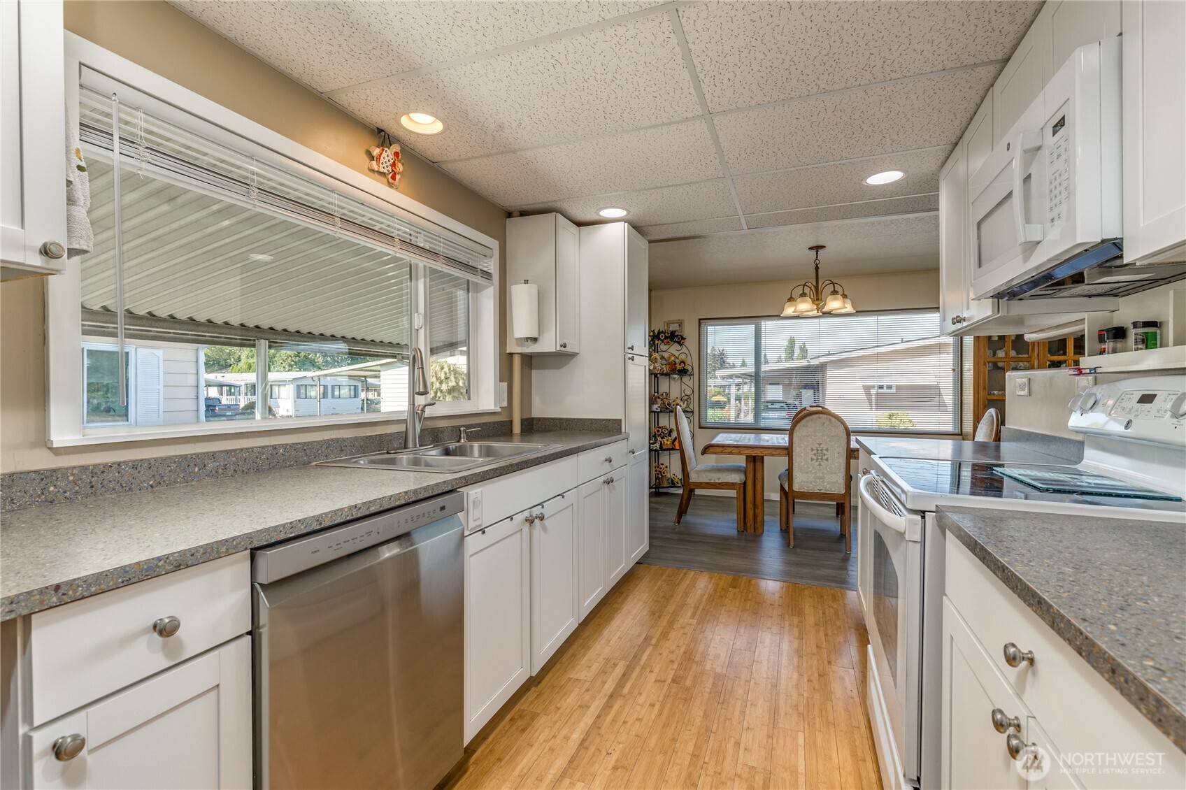 Bright kitchen with crisp white cabinets and newer appliances.
