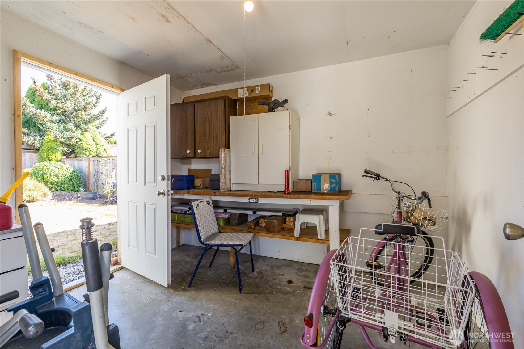 Workshop/storage room at back of carport offers access to the back yard as well