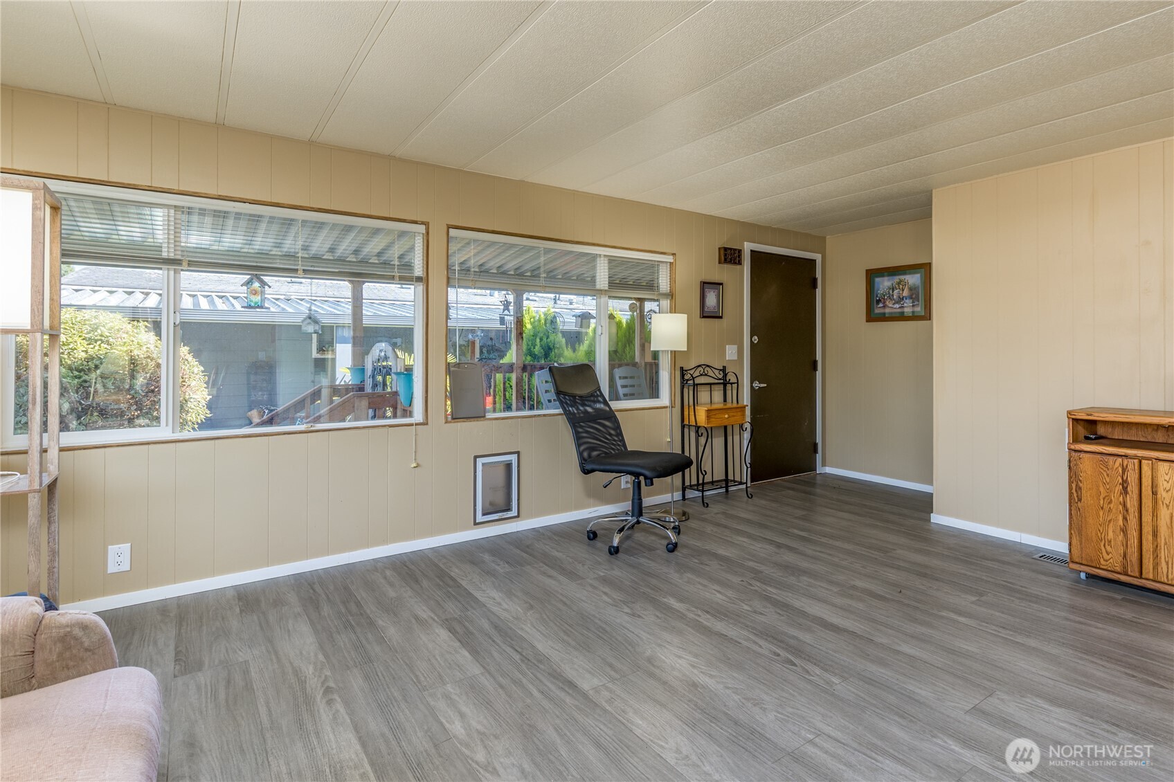 Living room with access to the covered back deck (and a pet door so your small animal can access the fully-fenced back yard too!)
