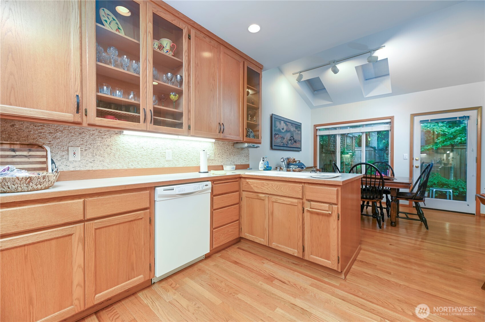 You will appreciate the cabinet and counter space in this amazing kitchen. Skylights with shades and door to the amazing courtyard.