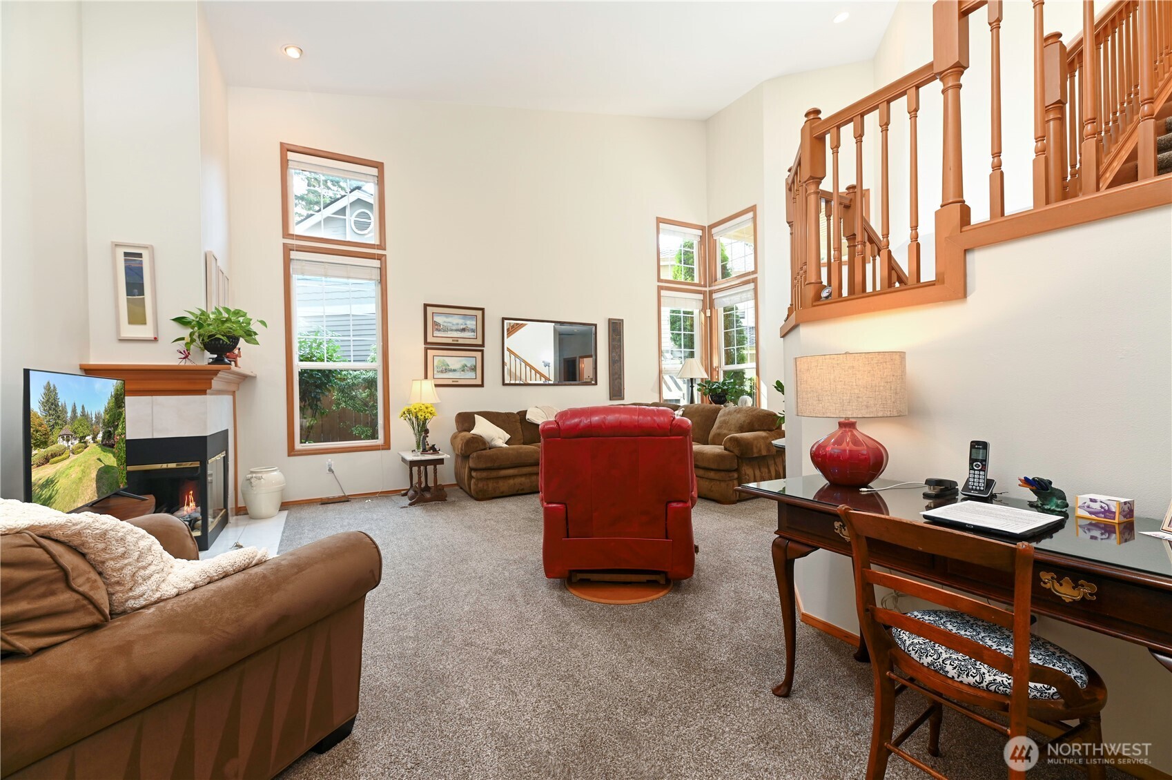 Warm wood wrapped windows and stair rails.
