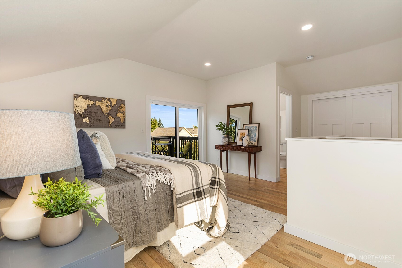 Loft primary bedroom leads to private deck