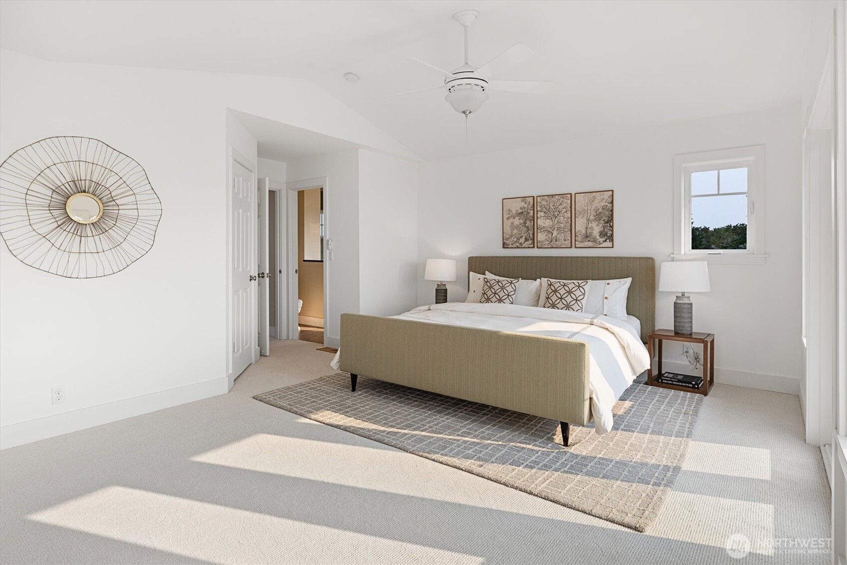 The spacious primary bedroom has been refreshed with new carpet and paint.