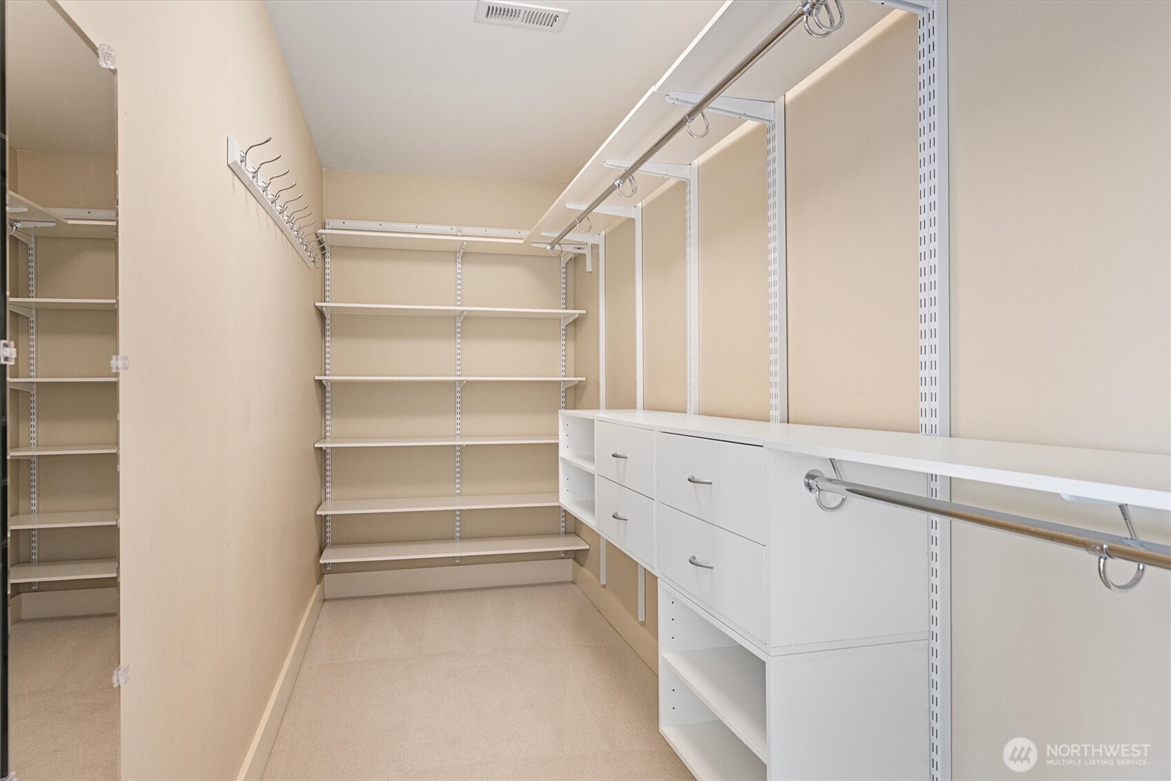 The primary suite is complete with dual walk-in closets—designed so both partners have their own spacious storage.