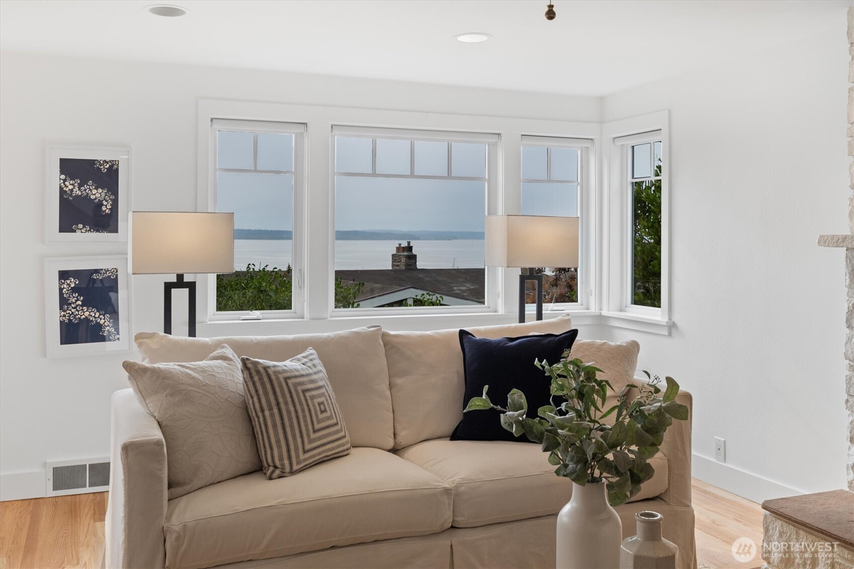 A bank of west-facing windows takes full advantage of natural light and frames colorful evening sunsets, filling the living room with warmth and glow.