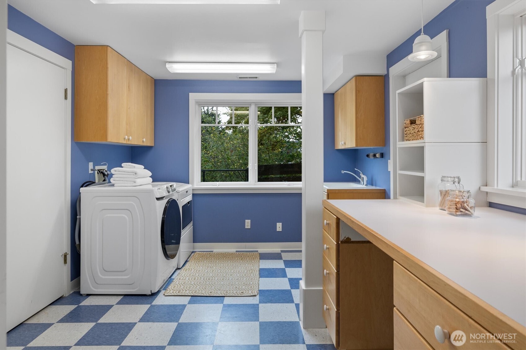 Spacious and versatile, the laundry room includes backyard access, ample cabinetry, and a generous counter that doubles as a folding station or a secondary work-from-home space.
