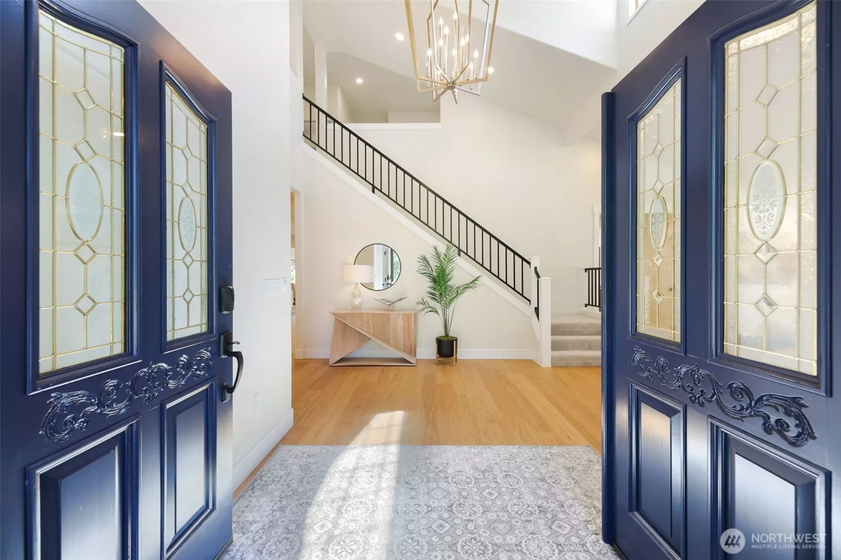 As you step through the French Door entry, the 2-story ceiling, custom railing and lighting immediately bring a sense of home!
