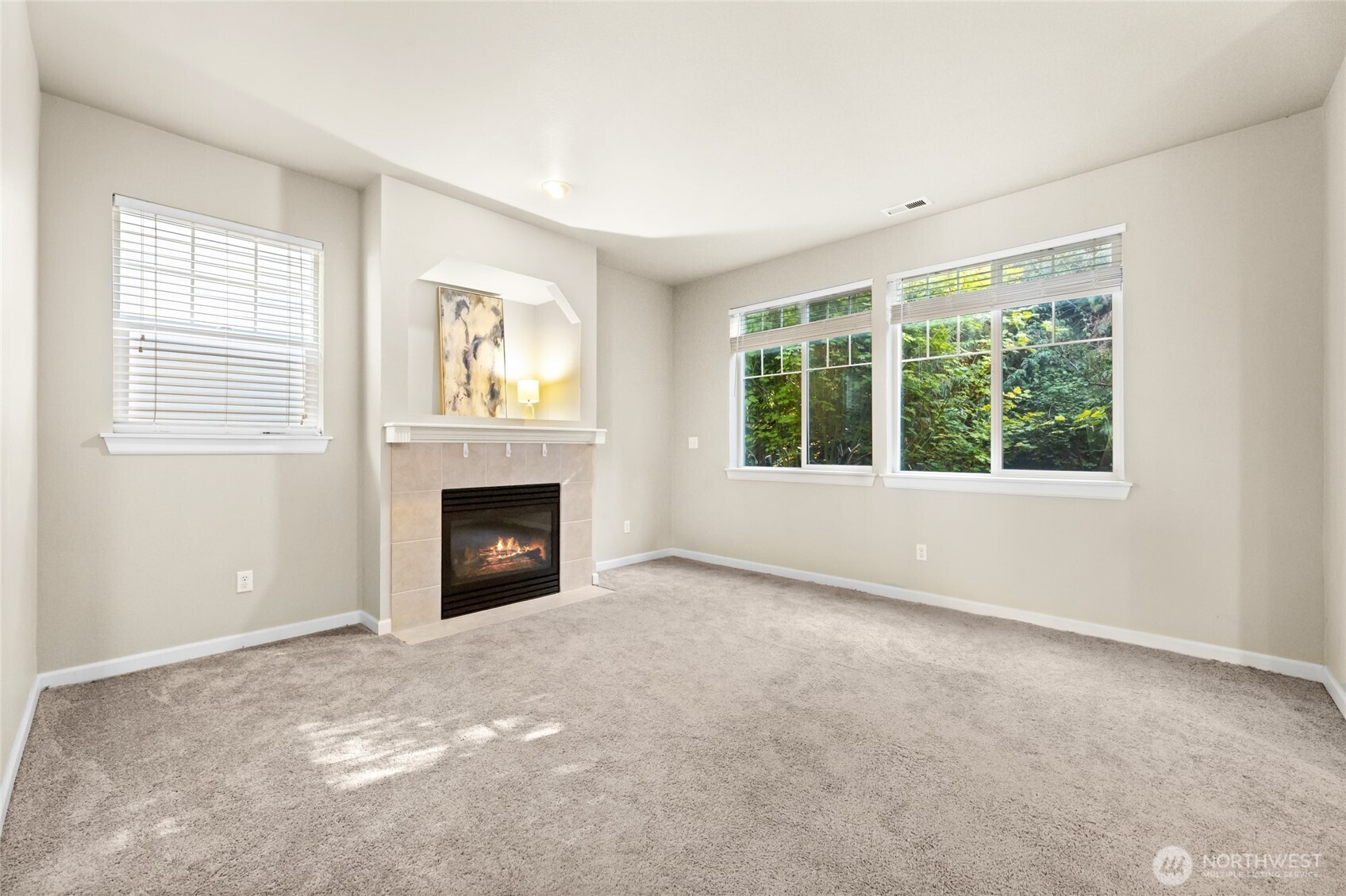 Family room with lots of windows and view to the backyard. Gas fireplace and cable outlets for TV to be placed above fireplace