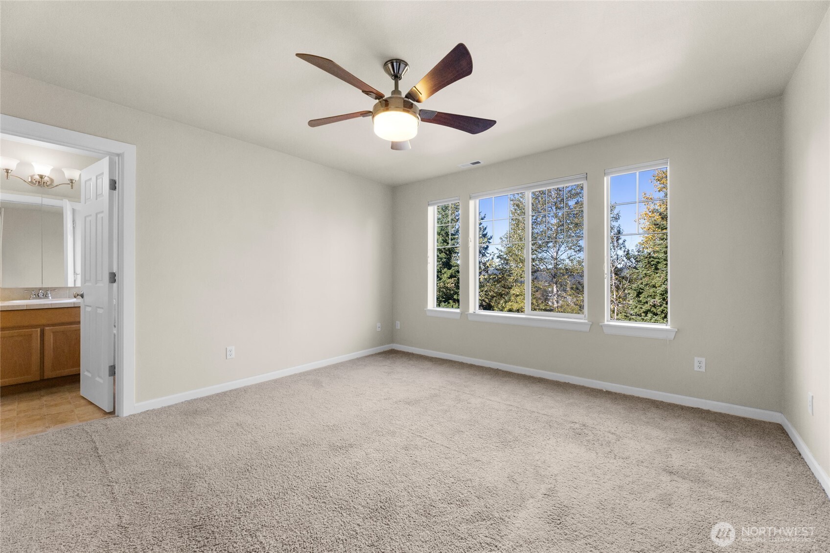 Primary bedroom with ceiling fan. The house has central AC too