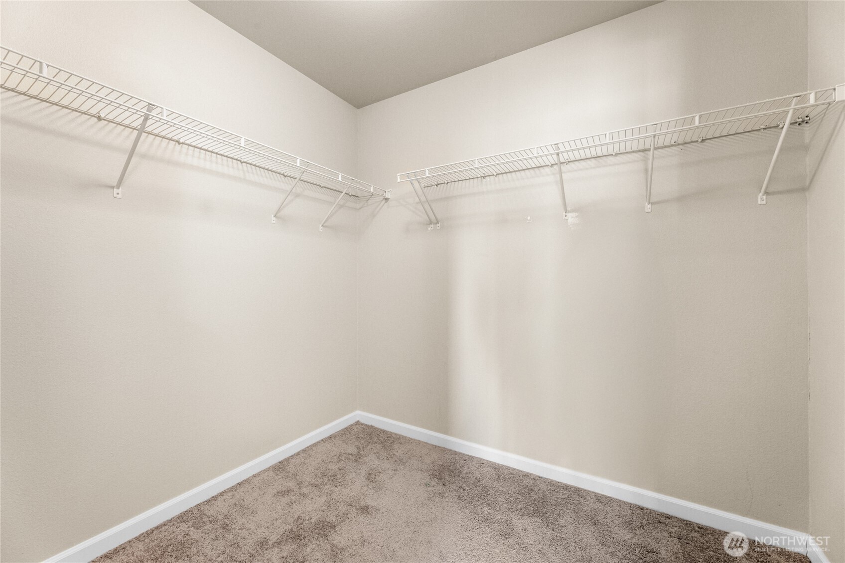 Primary bedroom walk in closet