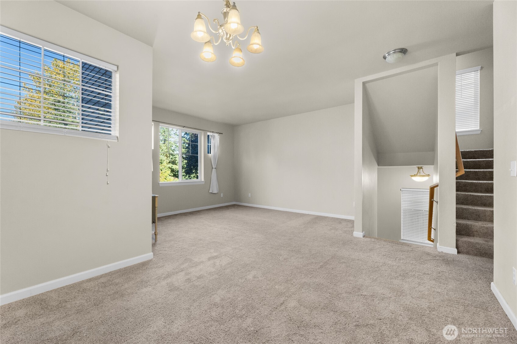 From the foyer there are stairs that lead to the formal living room and the dining room with views to the valley