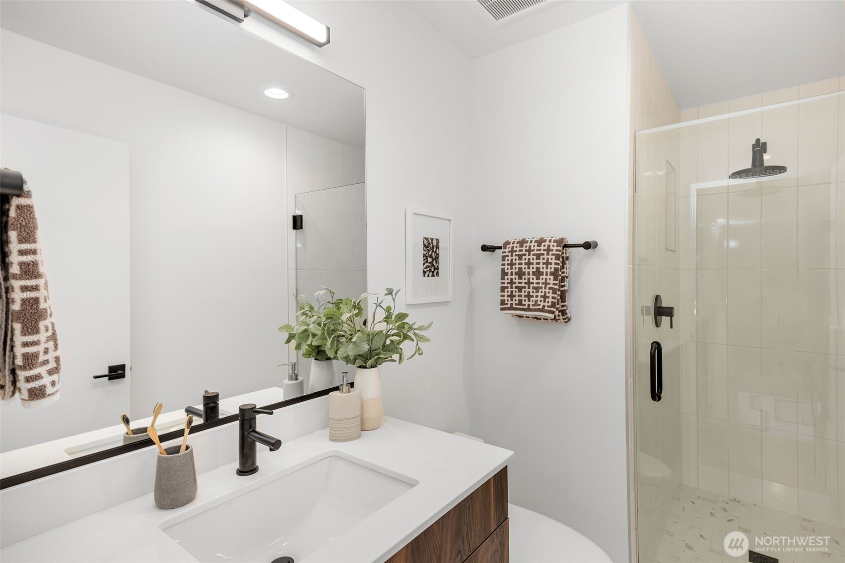 Primary suite offers two closest (one walk-in), en-suite bathroom.  Over size slider steps out to balcony.  Photo is of model home of same floorplan. Color schemes of finishes may vary.