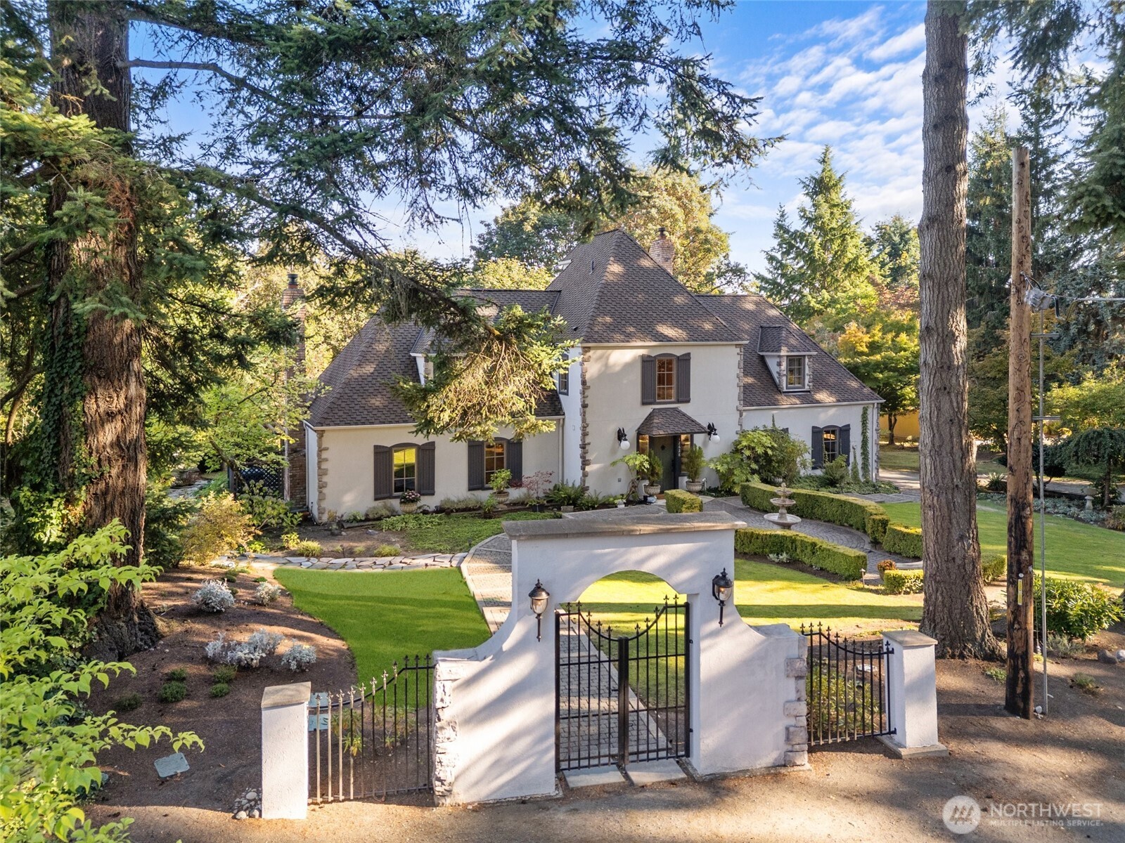 With charming wrought iron gate and lighted cobblestone paths.