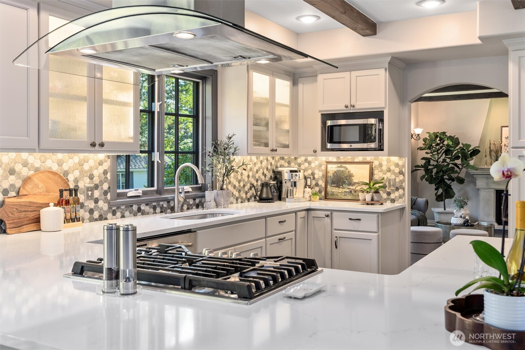 Large stainless sink overlooks the gardens, while windows swing open to let in fresh air.