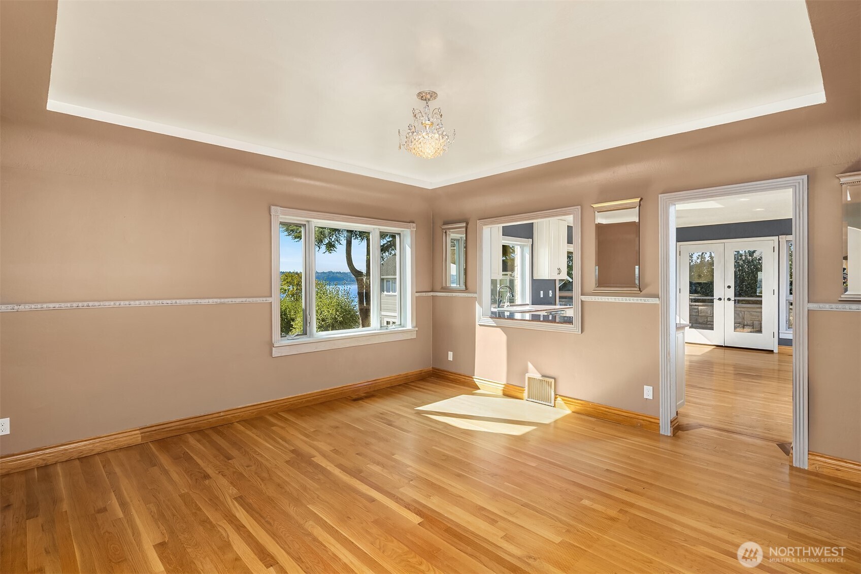 Formal dining with coved ceilings and pass through to the oversized chef's kitchen