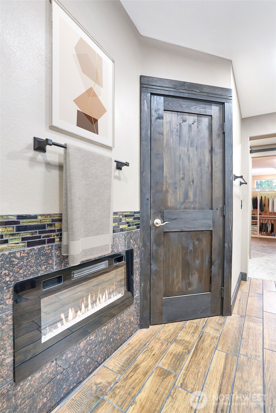 Primary bathroom with electric fireplace.