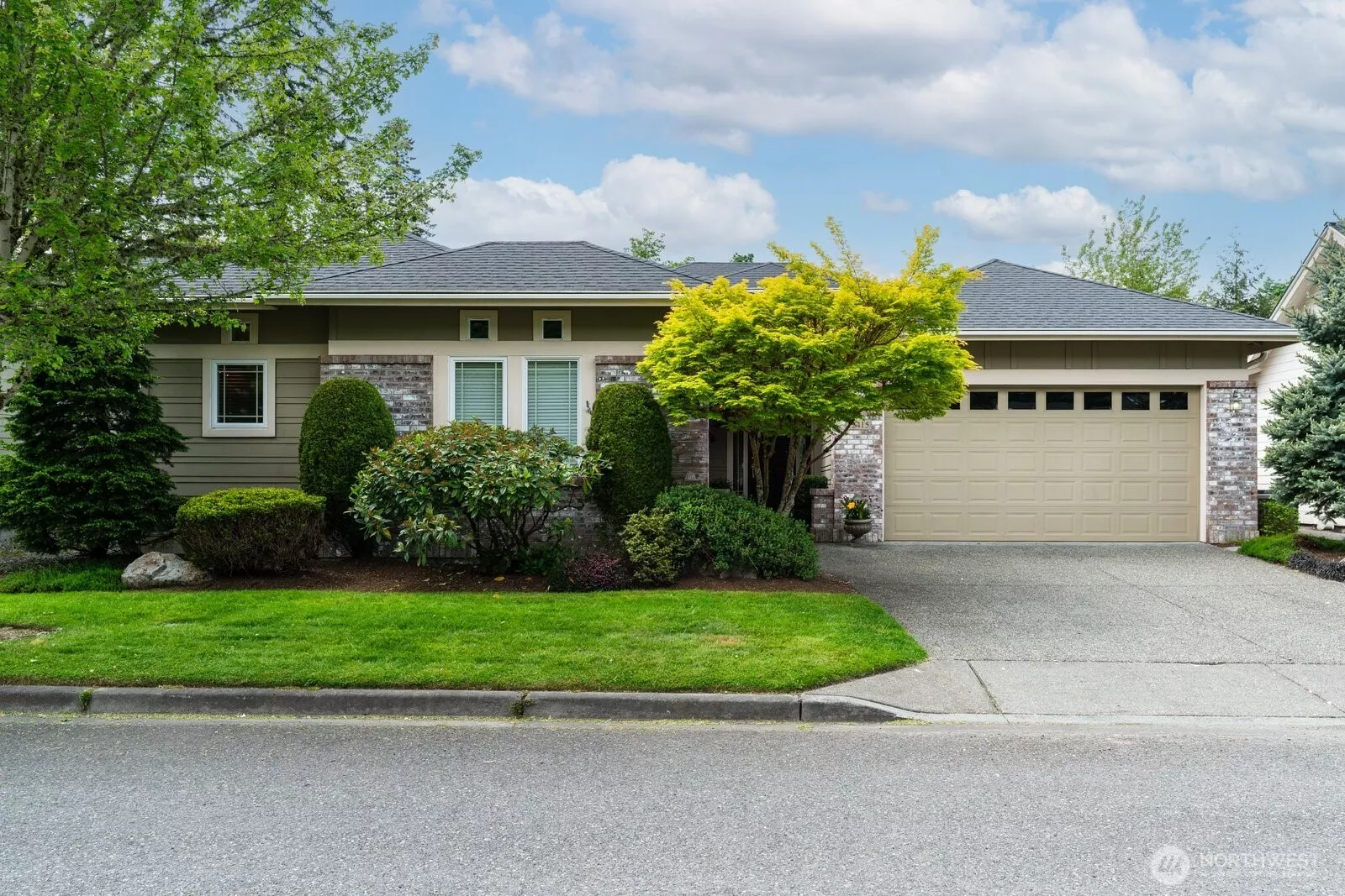 Sought after Hemlock floor plan with clean architectural lines and brick accents, garden walkway leading to covered front porch and mature landscaping.