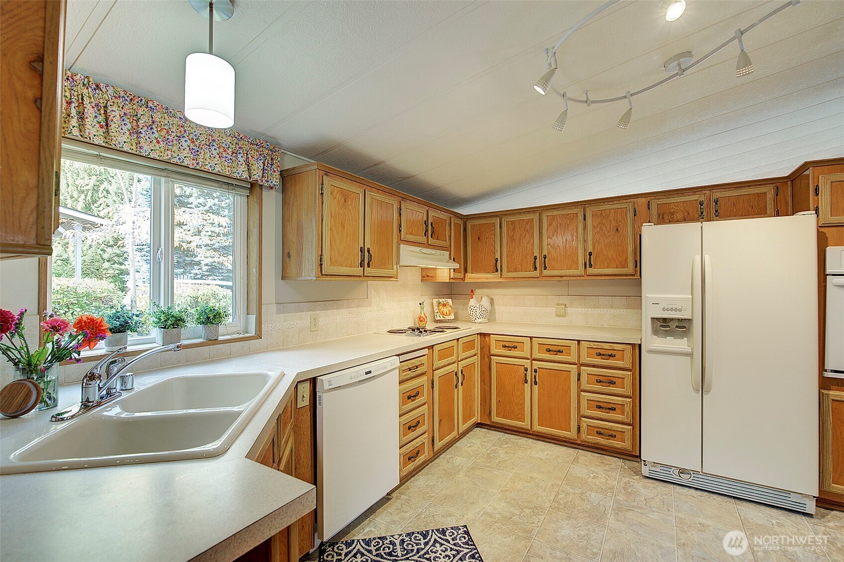 View of kitchen w/plenty of cupboards, counter space, new window & floors, new oven