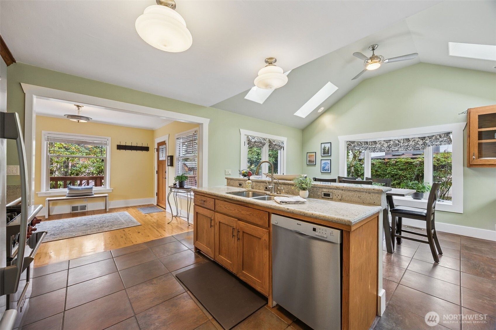 With ample windows, skylights and vaulted ceilings, the kitchen and dining spaces are light & bright!