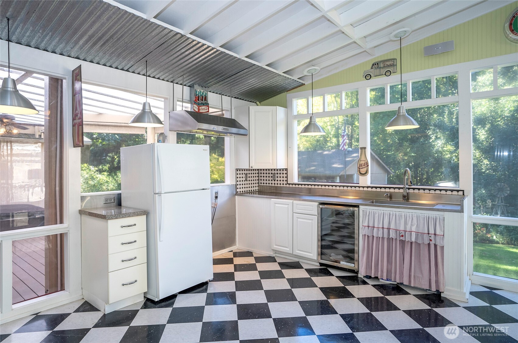 Covered and enclosed entertaining space with kitchenette—perfect for hosting gatherings.