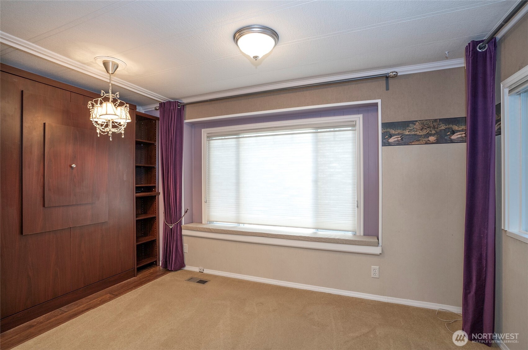 Spotlight on one end of the expansive walk-in closet, featuring ample storage and organization space.